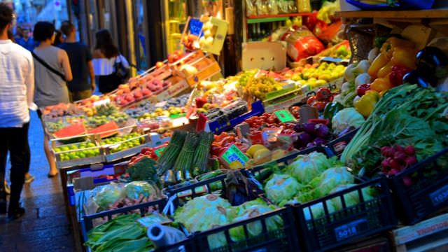 We shop in the medieval street market in Bologna's town center with fresh foods and vegetables. 